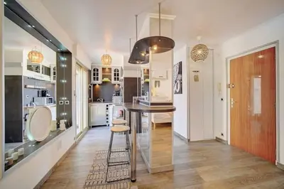 a kitchen with a table and a dining room at Beautiful 28m2 studio with balcony in Cannes