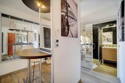 a dining room with a table and a kitchen at Beautiful 28m2 studio with balcony in Cannes