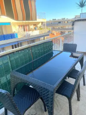 a table and two chairs on a balcony with a table and chairs at Beautiful 28m2 studio with balcony in Cannes