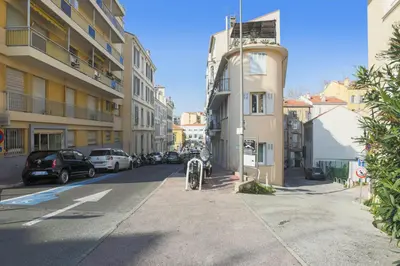 a street with cars parked on the side of a building at Studio Nid Doré - Welkeys in Cannes