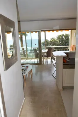 a kitchen and dining room with a view of the ocean at Cozy cocoon with balcony close to the sea in Cannes
