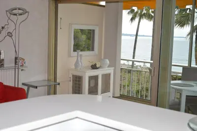 a living room with a view of the ocean at Cozy cocoon with balcony close to the sea in Cannes
