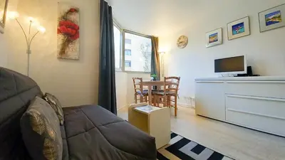 a living room with a couch and a tv at Les Félibriges in Cannes