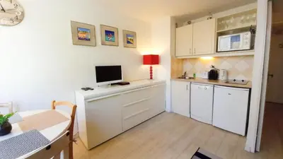 a kitchen with a desk with a computer on it at Les Félibriges in Cannes