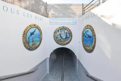 a hallway with four paintings of fish on the wall at A&H Homes - Cannes Beach - Near Train Station in Cannes
