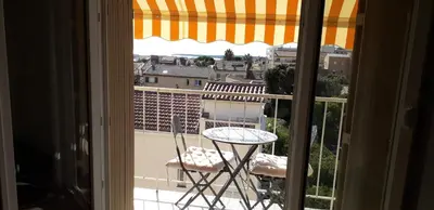 a view of a table and chairs from a window at Joli appartement vue sur mer in Cannes