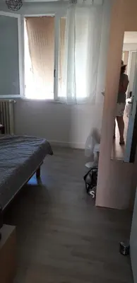 a person standing in a room with a window at Joli appartement vue sur mer in Cannes