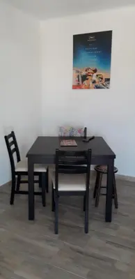 a black table with chairs and a picture on the wall at Joli appartement vue sur mer in Cannes