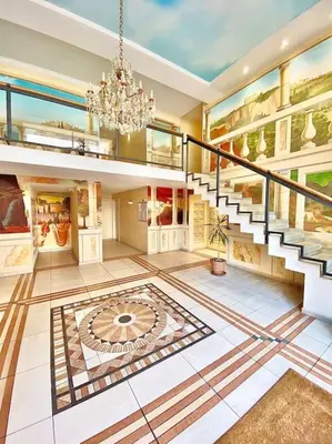 a large room with a staircase and a chandelier at Appartement Canne 1 chambre - 52C in Cannes