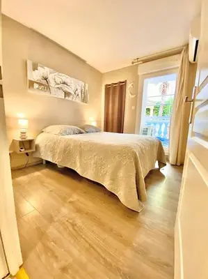 a bedroom with a bed and a large window at Appartement Canne 1 chambre - 52C in Cannes