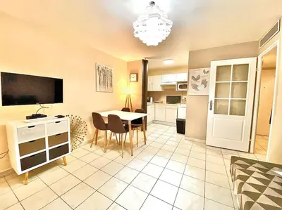 a kitchen and dining room with a table and chairs at Appartement Canne 1 chambre - 52C in Cannes