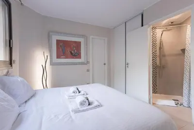 a bedroom with a white bed with towels on it at 