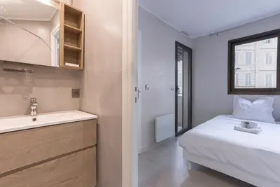 a small bathroom with a bed and a sink at 
