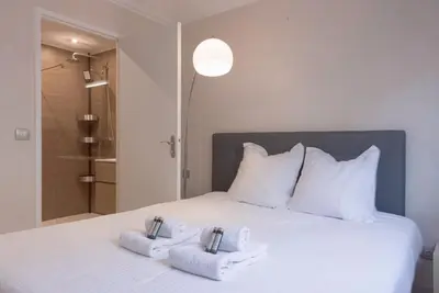a bedroom with a white bed with towels on it at 