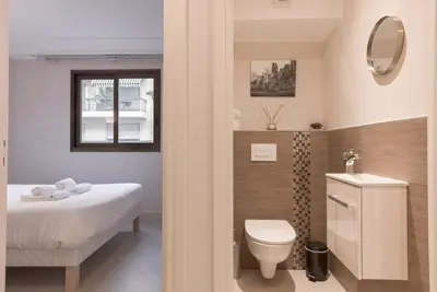 a bathroom with a bed and a toilet and a sink at 