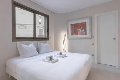a white bed with two towels on top of it at 