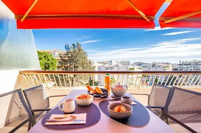 a table with bowls of food on a balcony at One BDRM flat A/C-Congress/Beaches by Olidesi in Cannes