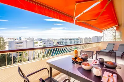 a balcony with a table with food on it at One BDRM flat A/C-Congress/Beaches by Olidesi in Cannes