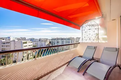 two chairs on a balcony with a view of the city at One BDRM flat A/C-Congress/Beaches by Olidesi in Cannes