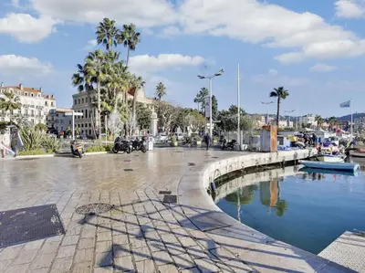 a city street with a pool of water and palm trees at One BDRM flat A/C-Congress/Beaches by Olidesi in Cannes