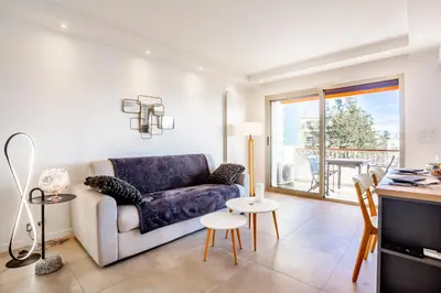 a living room with a couch and a table at One BDRM flat A/C-Congress/Beaches by Olidesi in Cannes