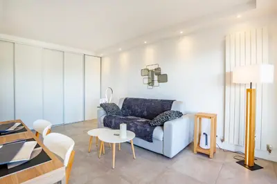 a living room with a couch and a table at One BDRM flat A/C-Congress/Beaches by Olidesi in Cannes