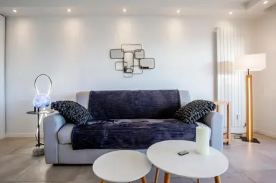 a living room with a couch and two tables at One BDRM flat A/C-Congress/Beaches by Olidesi in Cannes