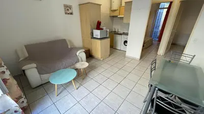 a small living room with a couch and a table at Modest one bedroom apartment in Cannes