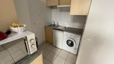 a kitchen with a washing machine and a dishwasher at Modest one bedroom apartment in Cannes