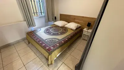 a small bedroom with a bed in a room at Modest one bedroom apartment in Cannes
