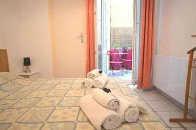 a hotel room with a bed with towels on it at Modest one bedroom apartment in Cannes