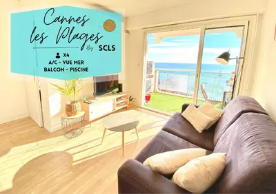 a living room with a couch and a view of the ocean at Cannes Les Plages By SCLS Locations in Cannes