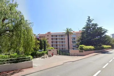 an empty street in front of a large building at Cannes Les Plages By SCLS Locations in Cannes
