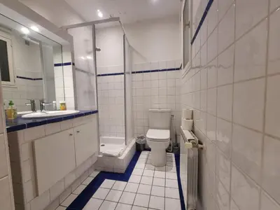 a bathroom with a toilet and a sink at CLEMENCEAU Plage Palais Cannes in Cannes