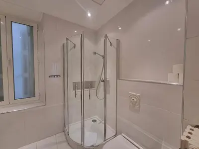a bathroom with a shower with a glass door at Appartement Commandant André in Cannes
