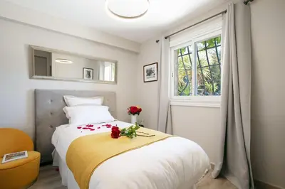 a bedroom with a large bed with roses on it at LE CASTEL ROSE Super Cannes, face aux Îles de Lérins in Vallauris