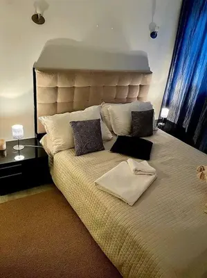 a large bed with pillows on it in a bedroom at Cœur de Cannes in Cannes