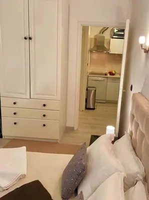a living room with a couch and a kitchen at Cœur de Cannes in Cannes