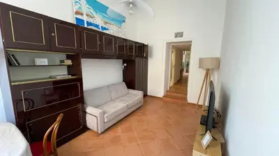 a person holding a stack of towels in a hotel room at Spacious and calm studio close to the beach in Cannes