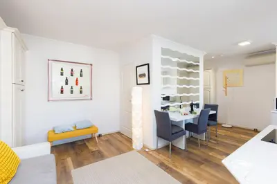 a living room with a table and chairs at Dolce Vita YourHostHelper in Cannes