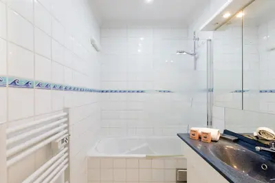 a bathroom with a sink and a bath tub at Dolce Vita YourHostHelper in Cannes