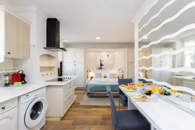 a kitchen and living room with a bed and a table at Dolce Vita YourHostHelper in Cannes