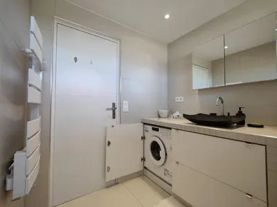 a kitchen with a washing machine and a sink at Cannes Vue mer T2 61m²+ parking in Cannes