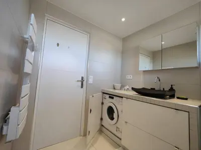 a kitchen with a washing machine and a sink at Cannes Vue mer T2 61m²+ parking in Cannes