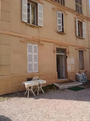 a building with a table and chairs in front of it at Beach House Cannes - Plages du Midi- 3 Ch - 3 Sdd - 2 wc - Fibre - Pkgs in Cannes
