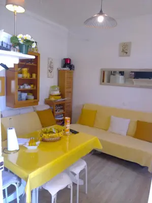 a living room with a yellow table and a couch at Beach House Cannes - Plages du Midi- 3 Ch - 3 Sdd - 2 wc - Fibre - Pkgs in Cannes