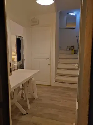 a hallway with a white table and a staircase at Beach House Cannes - Plages du Midi- 3 Ch - 3 Sdd - 2 wc - Fibre - Pkgs in Cannes