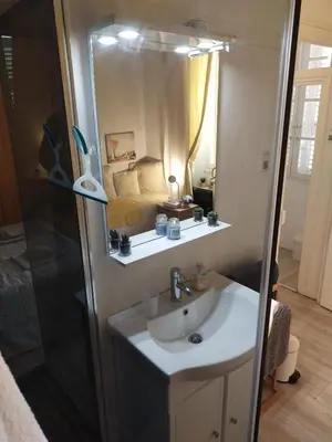 a bathroom with a sink and a bed in a room at Beach House Cannes - Plages du Midi- 3 Ch - 3 Sdd - 2 wc - Fibre - Pkgs in Cannes