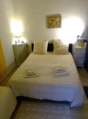 a bedroom with a large bed with two towels on it at Beach House Cannes - Plages du Midi- 3 Ch - 3 Sdd - 2 wc - Fibre - Pkgs in Cannes