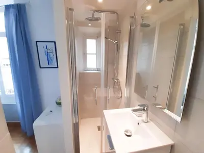 a bathroom with a sink and a shower with a mirror at Gloria in Cannes